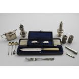 A MIXED LOT:- An ivory-handled cake knife in a fitted case, a Russian engraved tea spoon (in a box),