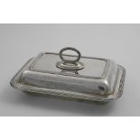 AN EDWARDIAN OBLONG ENTREE DISH AND COVER with rounded corners, reeded borders and a detachable ring