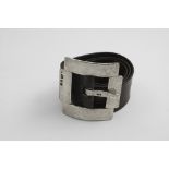 A LATE 20TH CENTURY LEATHER BELT with a large handmade buckle of shaped rectangular outline by