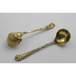 A MATCHED PAIR OF LATE 20TH CENTURY CAST SILVERGILT SAUCE LADLES in the rocaille manner, by C.J.