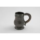 A RARE MOUNTED TURNED LIGNUM VITAE MUG of baluster form with a large c-scroll handle and lappet