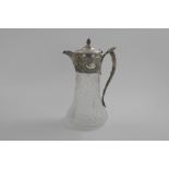 A VICTORIAN MOUNTED CUT-GLASS CLARET JUG with a flaring, star-cut base, an Etruscan style handle
