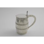 A GEORGE III TANKARD shaped like a barrel with reeded hoops and incised staves, with a flat cover, a