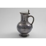 A VICTORIAN BRITANNIA STANDARD HOT WATER JUG OR EWER with a baluster body and spreading circular