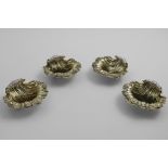 A SET OF FOUR EARLY VICTORIAN CAST SCALLOP SHELL SALTS with a chased border around the rim