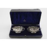 AN EDWARDIAN CASED PAIR OF BONBON DISHES of lobed outline with three handles by F.A. Burridge,