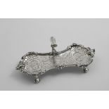 A GEORGE III ROCOCO REVIVAL SNUFFER TRAY OR STAND with a decorative cast border, flat-chased