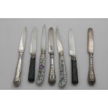 KNIVES:- A pair of 19th century French dessert knives with painted and gilt, glazed pottery handles,