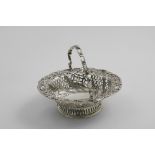 A VICTORIAN SWING-HANDLED BONBON DISH resembling a miniature George III cake basket, by Charles