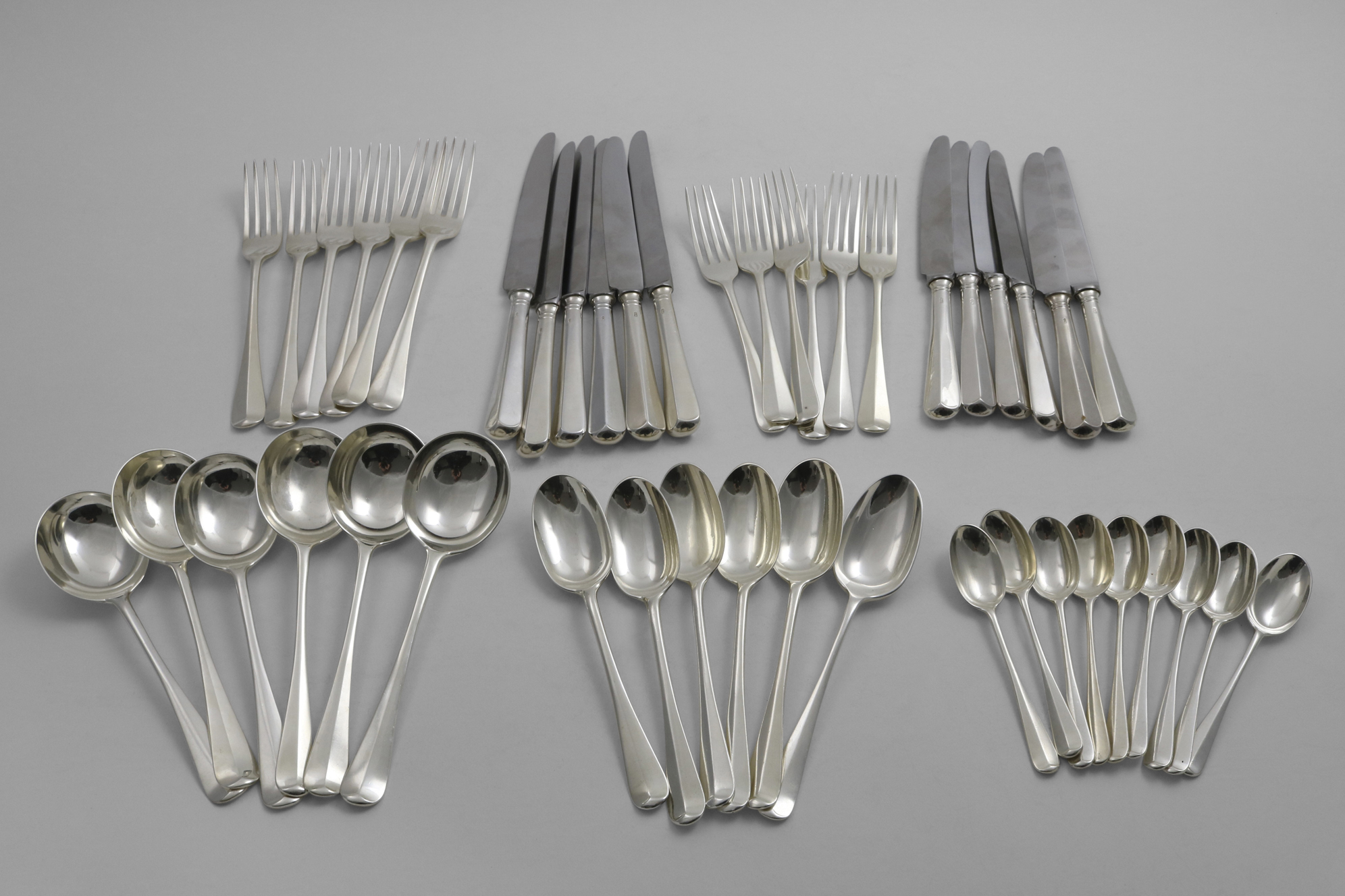 AN EARLY 20TH CENTURY PART-CANTEEN OF HANOVERIAN PATTERN FLATWARE & CUTLERY TO INCLUDE:- Six soup