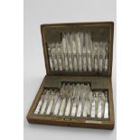 AN EARLY 20TH CENTURY CASED SET OF TWELVE PAIRS OF MOTHER OF PEARL HANDLED FRUIT KNIVES & FORKS by