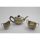 AN EDWARDIAN THREE-PIECE TEA SET oval with reeded borders and flat bases, by D & J. Wellby, London