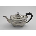 AN EARLY 20TH CENTURY BARGE-SHAPED TEA POT on bun feet, with a gadrooned border and a domed cover,