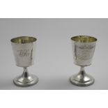 A PAIR OF GEORGE III WINE GOBLETS with gadrooned pedestal bases and pail-shaped bowls with gilt