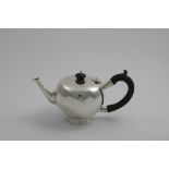 AN EARLY 20TH CENTURY BULLET TEA POT with a tapering hexagonal spout and c-scroll handle, by Charles