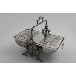 A VICTORIAN ELECTROPLATED, DUAL COMPARTMENT BISCUIT BOX on a rustic stand, with engraved foliate