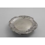 A LATE VICTORIAN DESSERT STAND OR TAZZA with embossed decoration around the rim and foot, and a