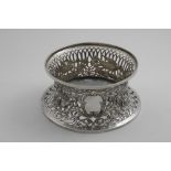 AN EDWARDIAN IRISH DISH RING of conventional spool form pierced around the sides and decorated