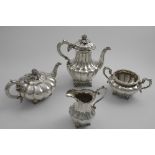 AN EARLY 19TH CENTURY MATCHED FOUR-PIECE TEA & COFFEE SERVICE of melon fluted design with shell