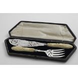 A CASED PAIR OF VICTORIAN FISH SERVERS with a pierced and engraved blade and tines, initialled,
