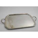 AN EARLY 20TH CENTURY TWO-HANDLED TRAY rectangular with incurved corners and a moulded border, by E.