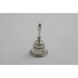 AN EARLY 20TH CENTURY CAST BELL with a baluster handle and reeded girdle, by Robert Dicker & Co.,