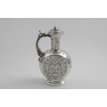 AN EARLY VICTORIAN HOT WATER JUG in the form of a moon flask with engraved decoration, a plain