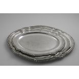 A GRADUATED SET OF THREE MEAT DISHES of shaped oval outline with gadrooned borders, crested, by