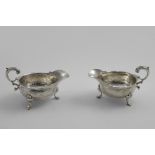 A PAIR OF GEORGE II SAUCE BOATS on three legs with stepped hoof feet and shaped knuckles, the bodies