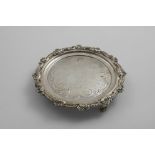 A GEORGE III WAITER with a gadroon and foliate border, flat-chased decoration around a central,