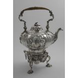 A VICTORIAN ROCOCO REVIVAL KETTLE ON STAND with burner with a swing handle and a cast, openwork