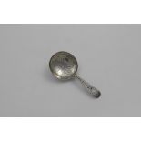 A GEORGE III ENGRAVED CADDY SPOON with a circular bowl and a bright-cut stem, initialled "M" over "