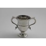 A GEORGE III LOVING CUP with a campana-shaped bowl, a circular pedestal foot and two, s-scroll