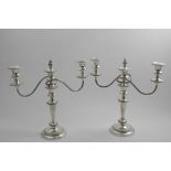 A PAIR OF LATE 20TH CENTURY THREE-LIGHT CANDELABRA on circular bases with reeded scroll branches,