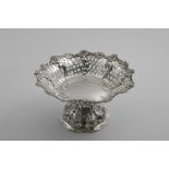 A LATE VICTORIAN PIERCED FRUIT DISH on a pedestal foot with applied flower borders by W. Gibson & J.