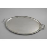 AN EARLY 20TH CENTURY TWO-HANDLED OVAL TRAY with reeded borders, by A & F. Parsons (for Tessiers
