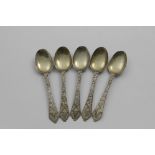 A SET OF FIVE WILLIAM & MARY SILVERGILT TREFID SWEETMEAT SPOONS with engraved decoration, a mask