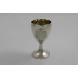 A GEORGE III WINE GOBLET with a pedestal base and a gilt interior, engraved on one side with a