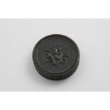 AN EARLY 19TH CENTURY PRESSED HORN CIRCULAR SNUFF BOX dark in colour, with a putto, roses, a bee and