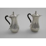 A PAIR OF EARLY 20TH CENTURY CAFE AU LAIT POTS in the style of George III hot-water jugs, of