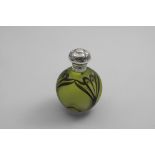 AN EDWARDIAN ART NOUVEAU MOUNTED GREEN GLASS SCENT BOTTLE globular with pointed and gilt decoration,