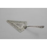 AN EARLY GEORGE III FISH SLICE with a pierced, triangular blade and a cast handle with a husk &