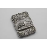 A VICTORIAN EMBOSSED "CASTLE TOP" CARD CASE of shaped rectangular outline with scroll borders and