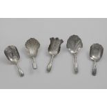 FIVE VARIOUS ANTIQUE CADDY SPOONS with hollow Fiddle pattern stems and engraved decoraitons (two