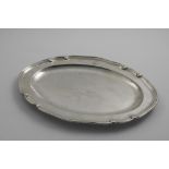 A GEORGE III MEAT DISH of shaped oval outline, the border interspersed with shell motifs, crested