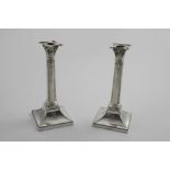A PAIR OF LATE VICTORIAN NEO-CLASSICAL CANDLESTICKS on bevelled square bases with cylindrical