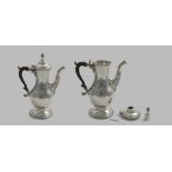 A GEORGE III BALUSTER CHOCOLATE POT on a spreading circular foot with a leaf-wrapped spout, a