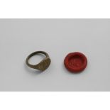 A 16TH / EARLY 17TH CENTURY BRONZE MERCHANT'S SEAL RING with intaglio initials "TM" and the