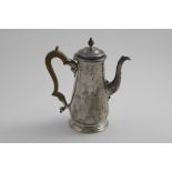 A GEORGE II COFFEE POT with a tapering body, tucked-in base and spreading circular foot, the spout