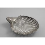 A LATE VICTORIAN DESSERT DISH in the form of a scallop shell with piercing and chased decoration,